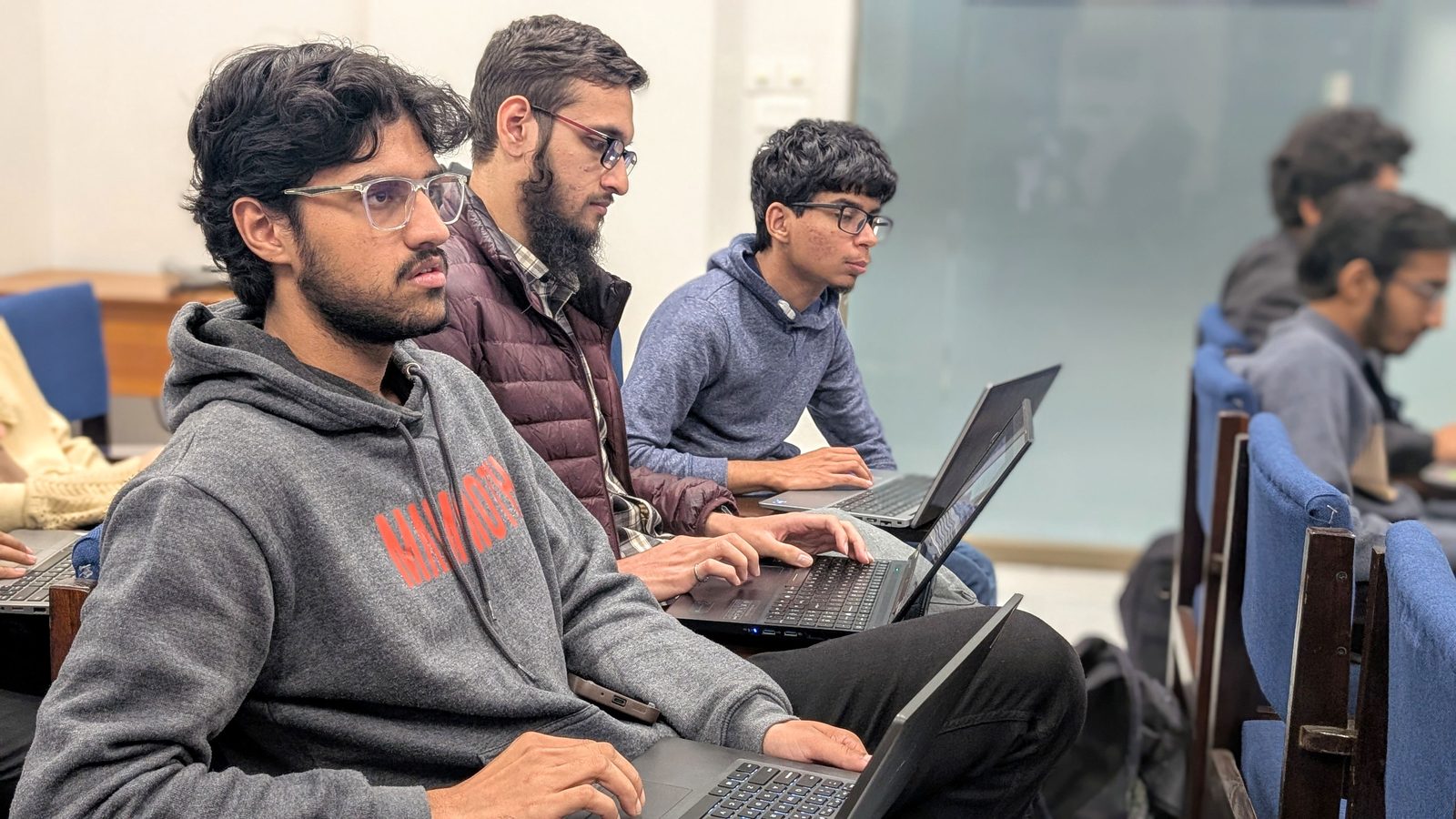 Participants working through a Qiskit lab on their laptops.