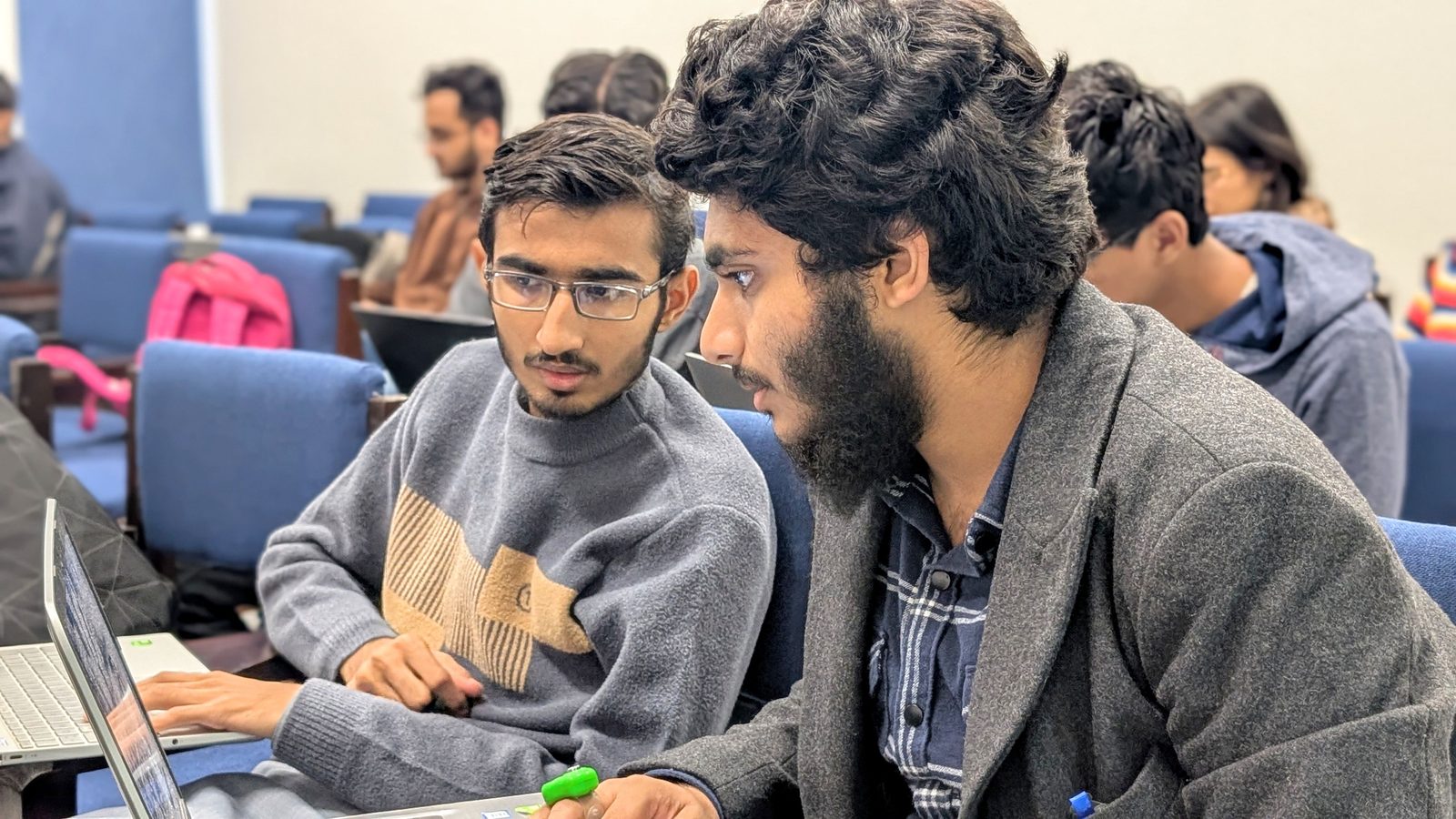 Two teammates debugging a circuit together during the hackathon.